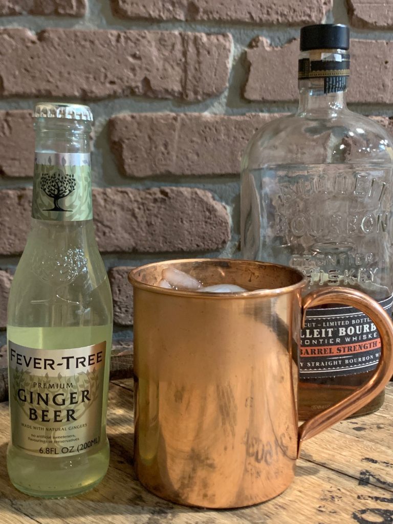 Image of copper mug, ginger beer, and Bulleit Bourbon