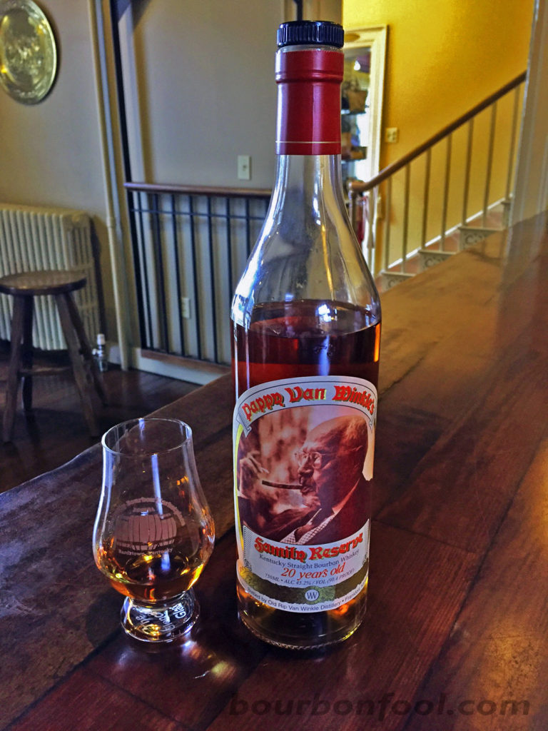 A bottle and tasting glass of Pappy Van Winkle 20 year old bourbon