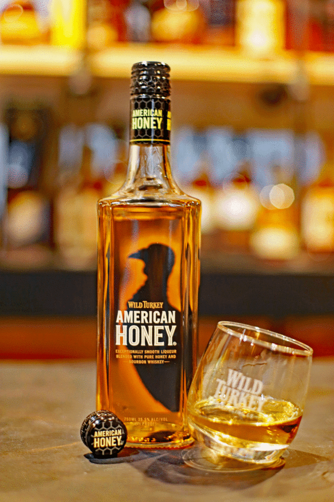 Bottle and glass of Wild Turkey American Honey