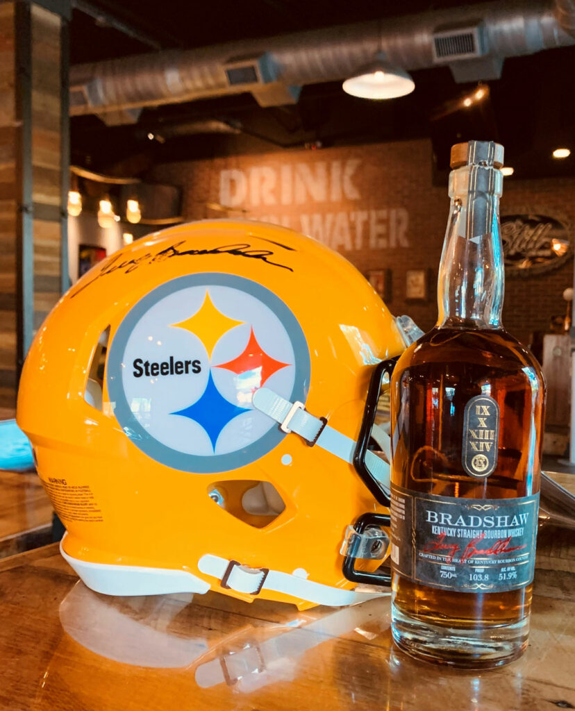 Bradshaw Bourbon next to a Pittsburgh Steelers helmet